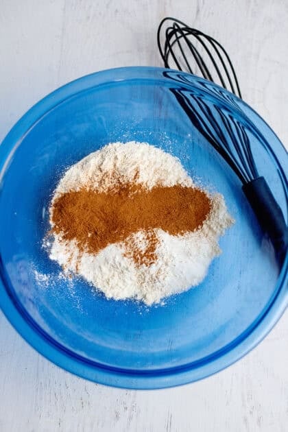 A mixing bowl with dry ingredients for the pumpkin roll