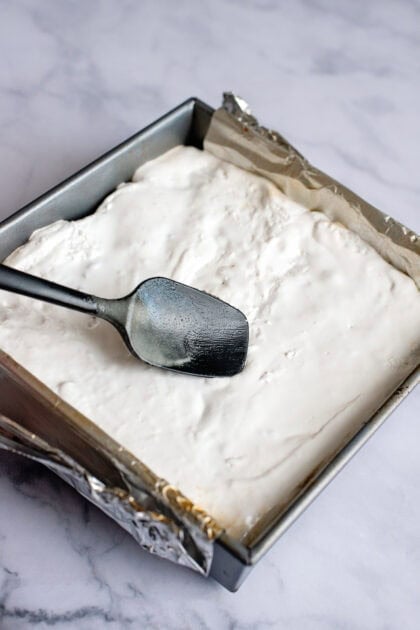 Spreading marshmallow on the s'mores brownies