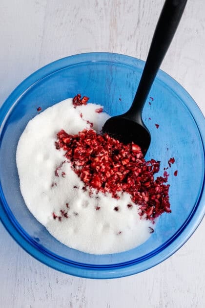 Bowl of chopped cranberries and sugar