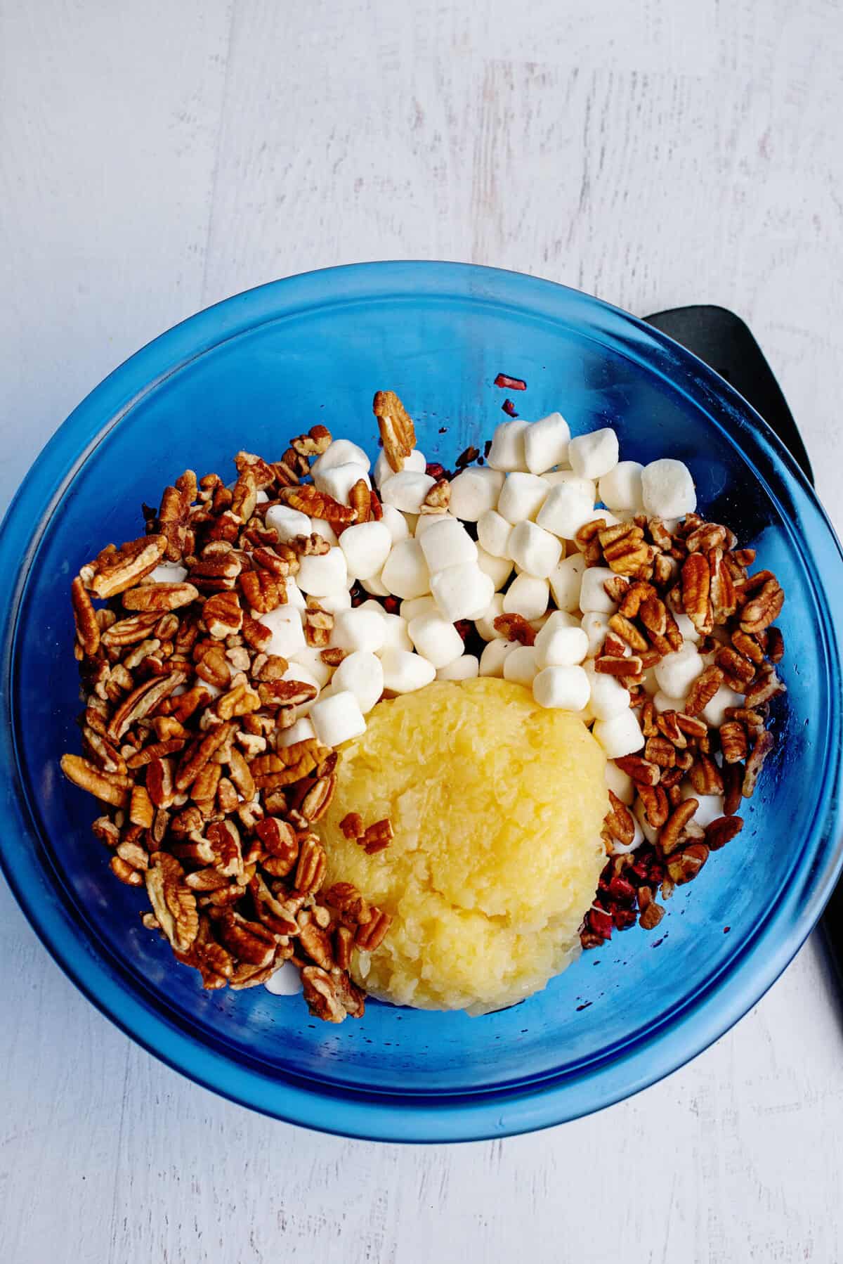 A bowl of mix-ins for cranberry fluff salad