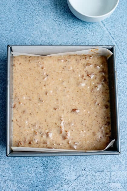 Spreading the eggnog fudge mixture in a baking pan
