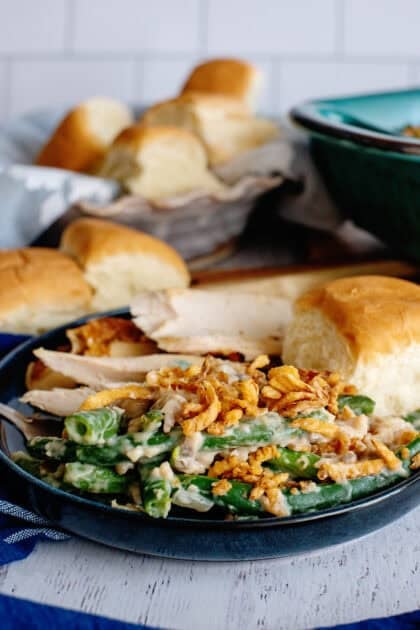 Green bean casserole served with a roll and turkey