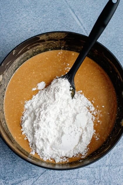 Adding powdered sugar to peanut butter fudge mix
