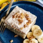 A plate with a banana bread cake bar and sliced bananas