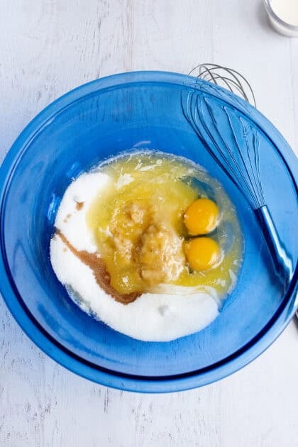 A bowl of wet ingredients for the banana bread cake bars
