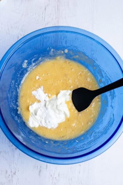 Stirring the sour cream into a bowl of other wet ingredients