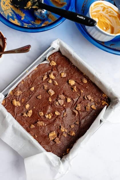 Chopped peanut butter cups on top of the chocolate layer