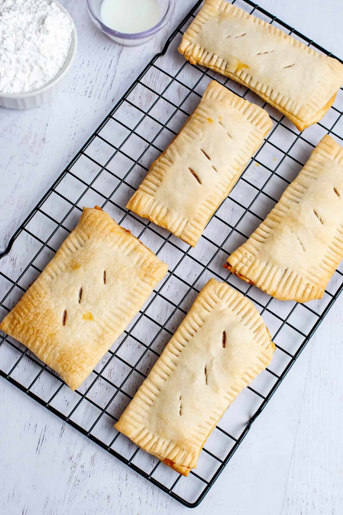 Homemade strawberry pop-tarts on a cooling rack