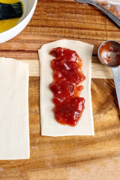 Adding the strawberry filling to squares of refrigerated pie crust