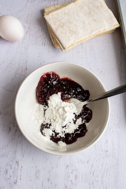 Jam and cornstarch in a small mixing bowl