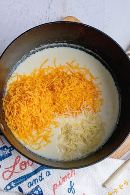 Shredded cheese in a pan of melted butter, flour, and milk