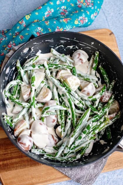 Combining all the ingredients to make creamed beans and taters