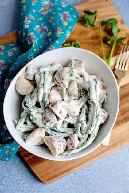 A bowl of creamed beans and Taters on a cutting board