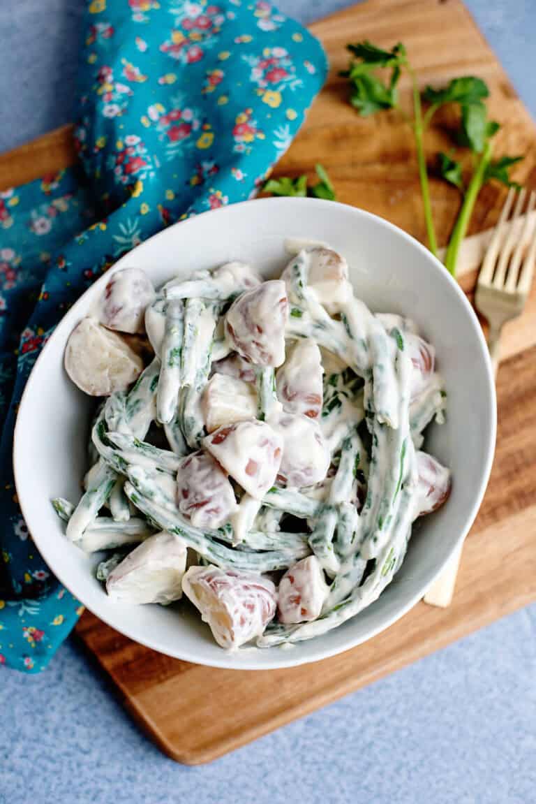 A bowl of creamed beans and Taters on a cutting board