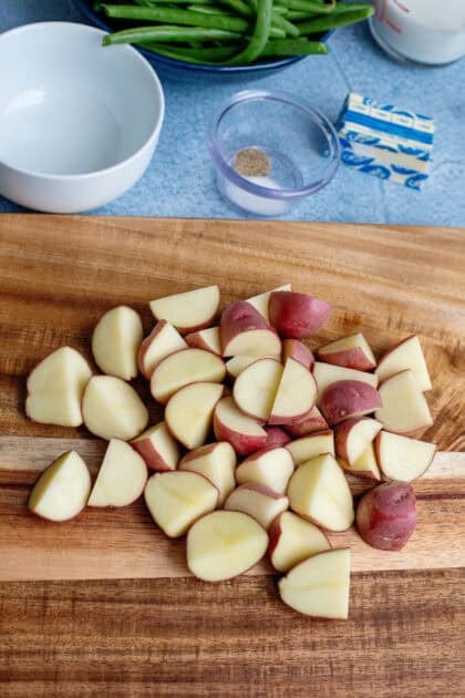 Quartered new potatoes on a cutting board