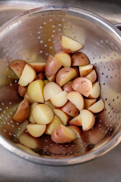 Potatoes draining in a colander