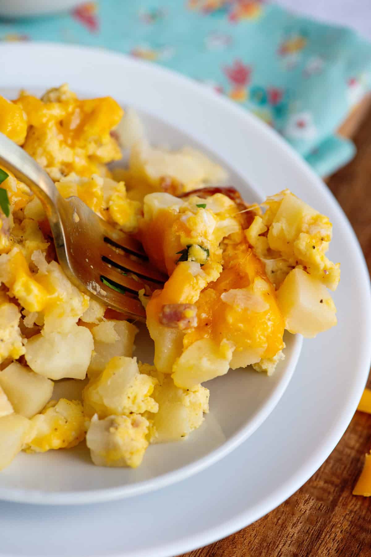 Ham, egg, and cheese casserole on a white plate.