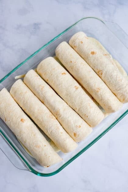 Honey Lime Chicken Enchiladas in a baking pan