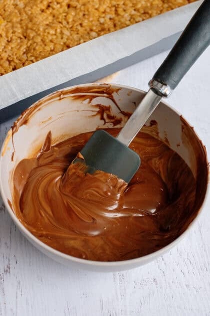 Chocolate chips and butterscotch being mixed in a saucepan