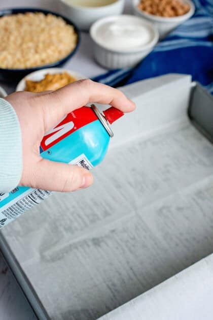 Greasing a pan with parchment paper and cooking spray