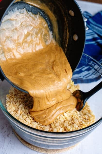 Coating the crisp rice cereal with the peanut butter mixture
