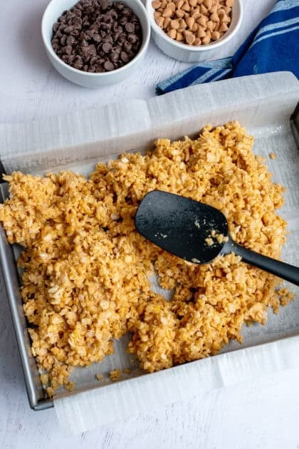 Pressing the coated cereal mix into a pan