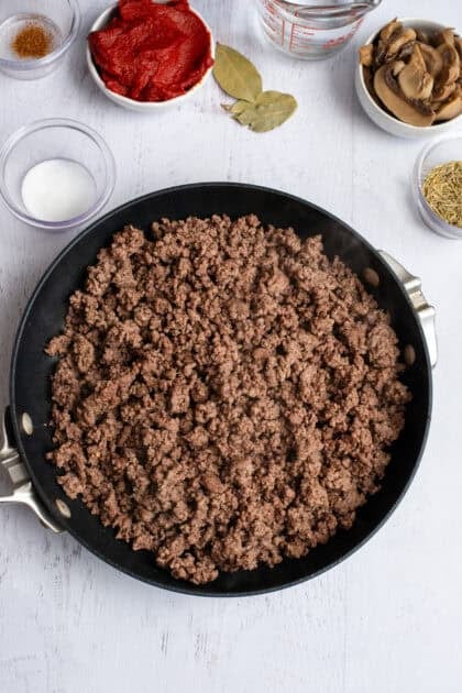 Browned and cooked ground beef in a skillet