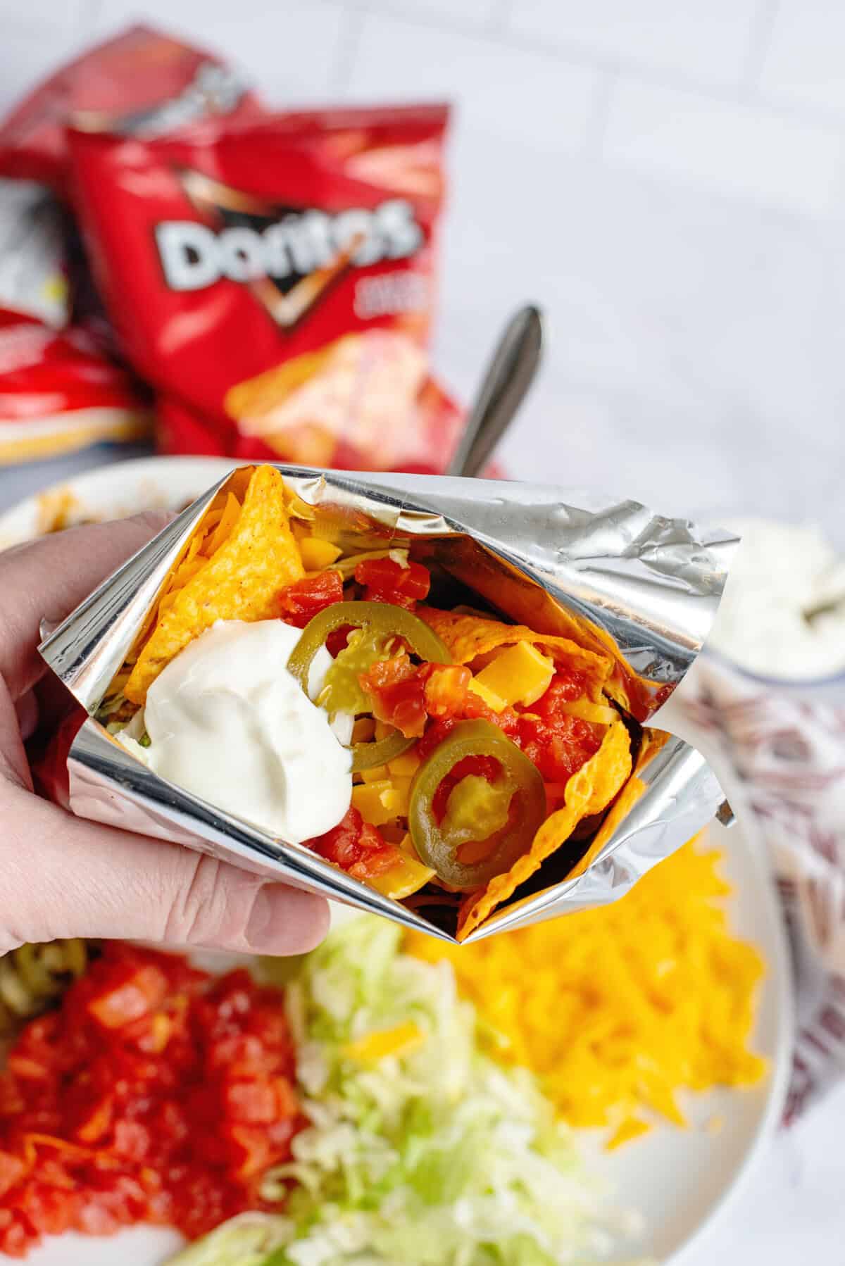 Holding a bag of walking tacos