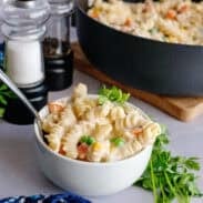 A bowl and pan of chicken pot pasta