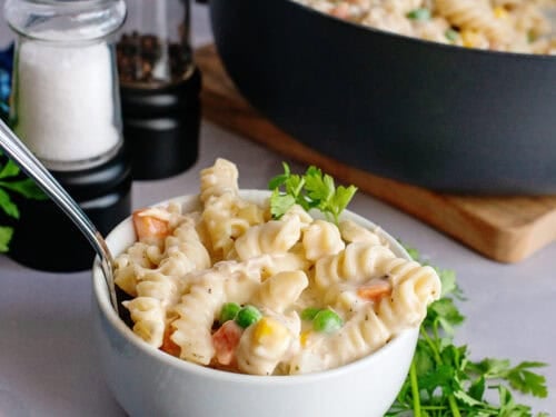 A bowl and pan of chicken pot pasta