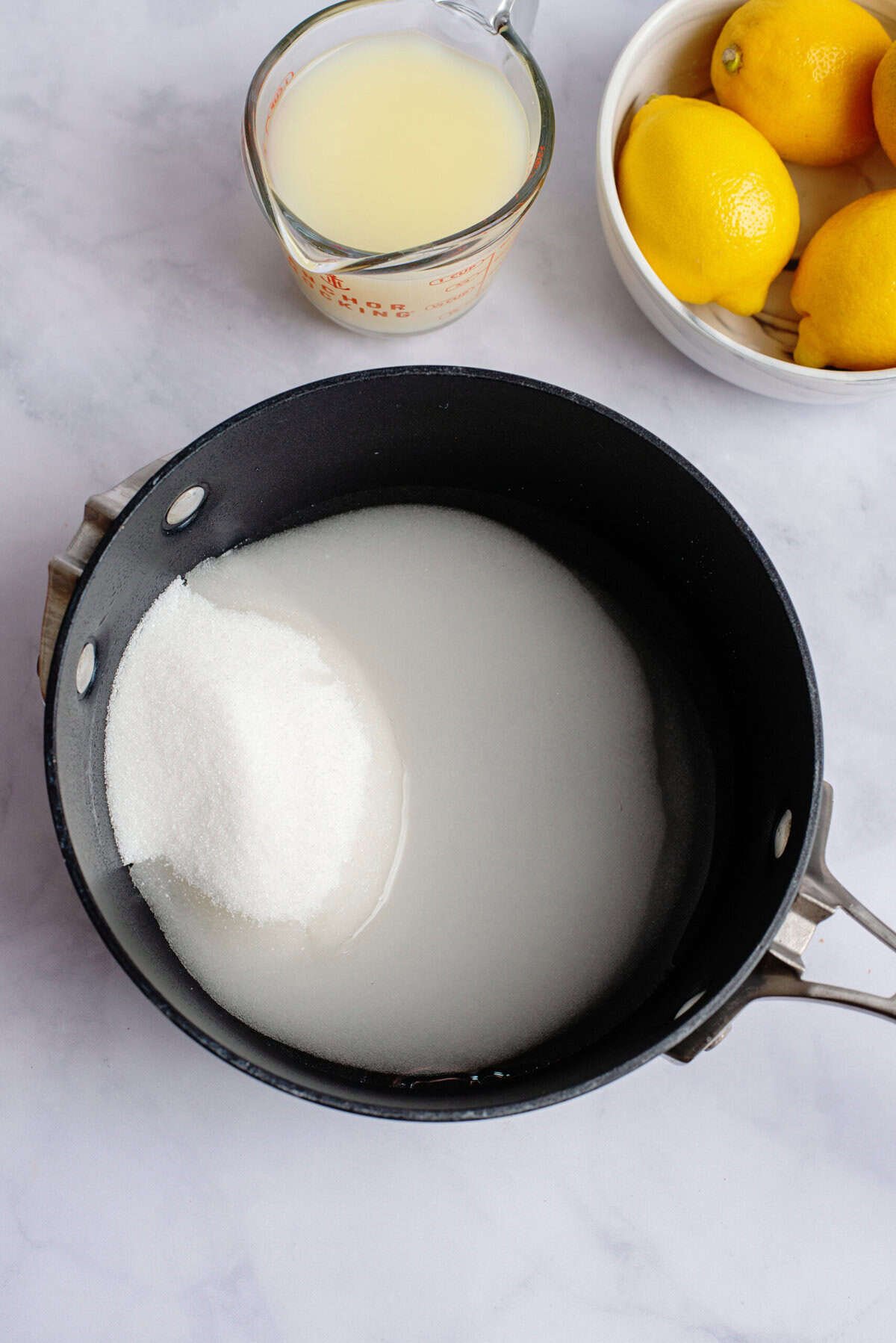 Mixing sugar and water in a small saucepan