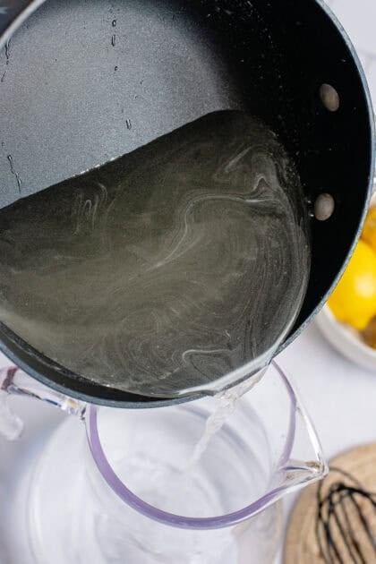Adding warm sugar syrup to a pitcher
