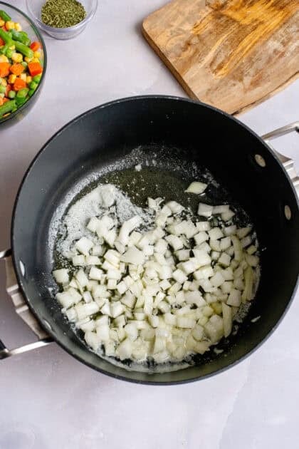 Onions being sauted in a skillet