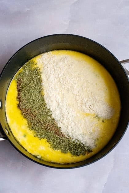 Adding cream and seasoning to a pot of low carb vegetable soup