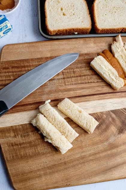 Slicing the cream cheese sandwiches into sticks