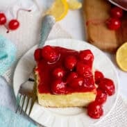 A plate with one serving of lemon cherry cheesecake