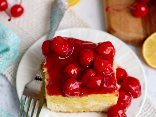 A plate with one serving of lemon cherry cheesecake