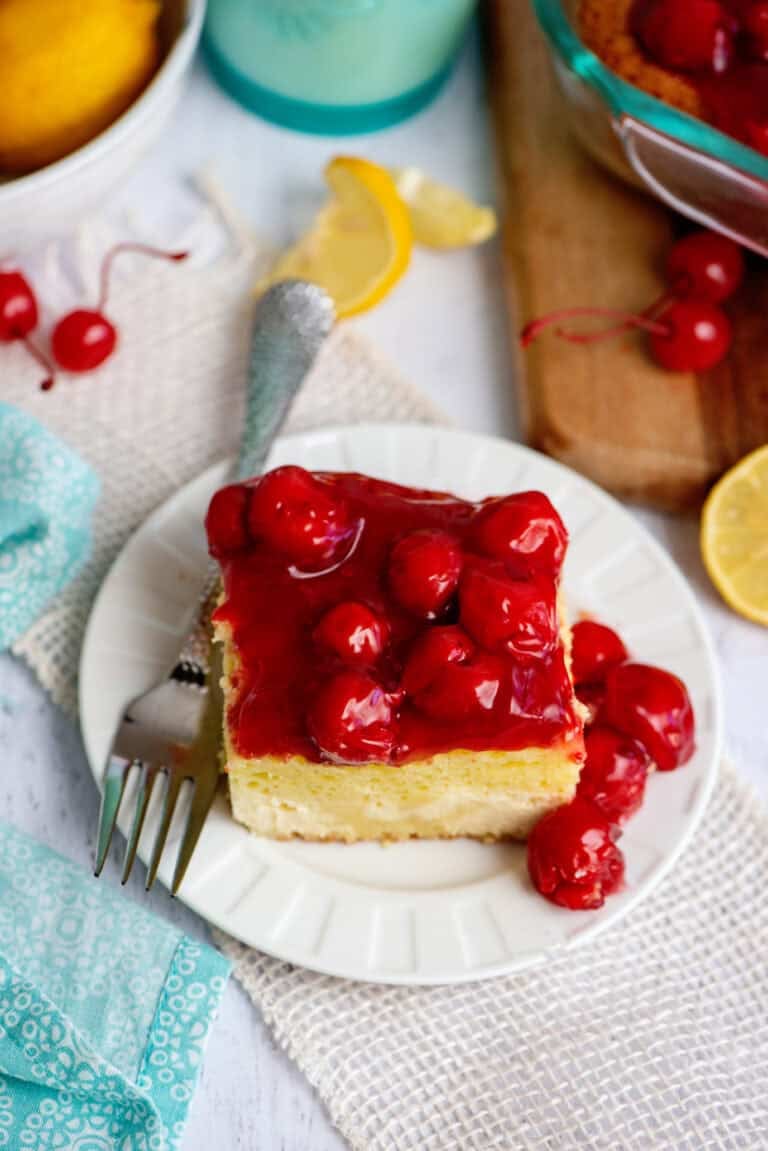 A plate with one serving of lemon cherry cheesecake