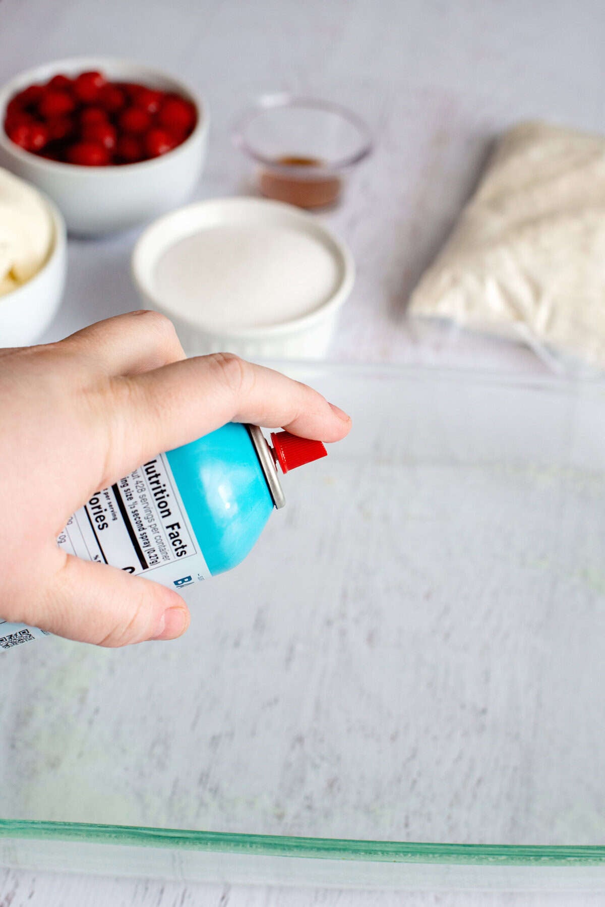 Spraying a baking pan with non-stick spray