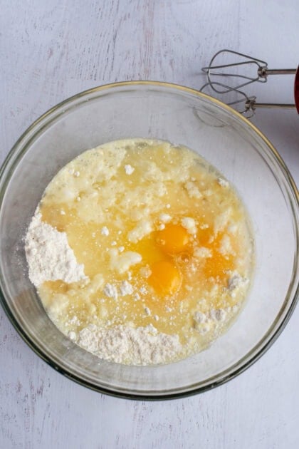 ricotta, eggs, sugar, and vanilla being mixed in a bowl