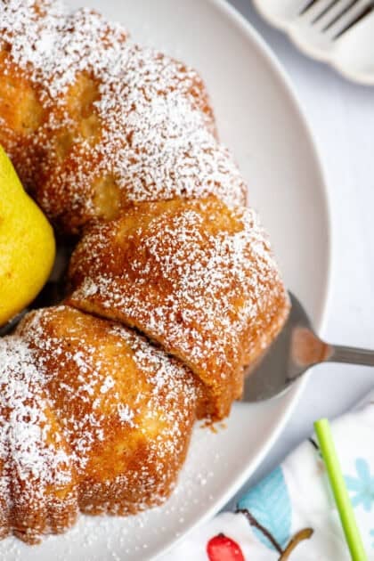 Close up of a sliced pear bundt cake with pear in the middle