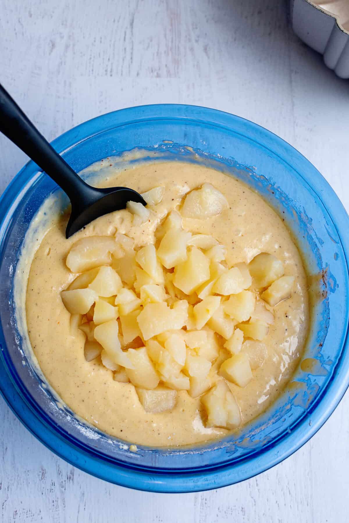 Adding pears to the bundt cake batter
