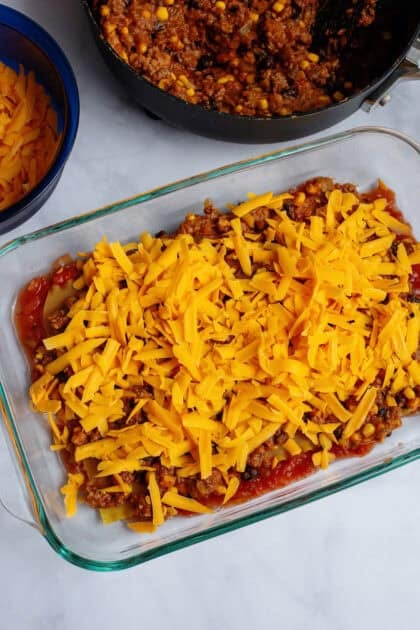 Adding cheese layer to the baking dish of Tex Mex Lasagna