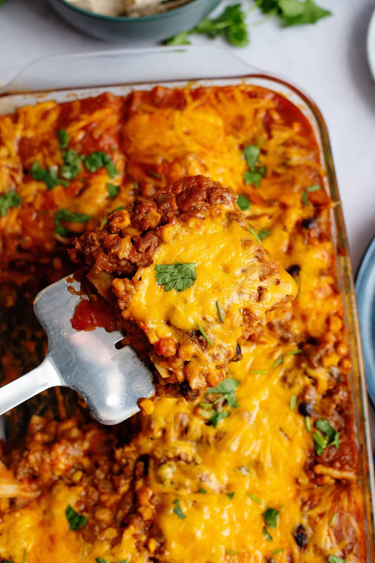 Using a spatula to serve Tex Mex Lasagna