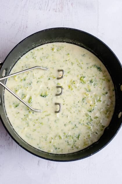 Mashing Broccoli Cheese and Bacon Soup