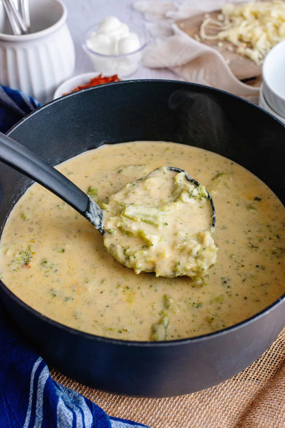 Using a ladle to serve Broccoli Cheese and Bacon Soup