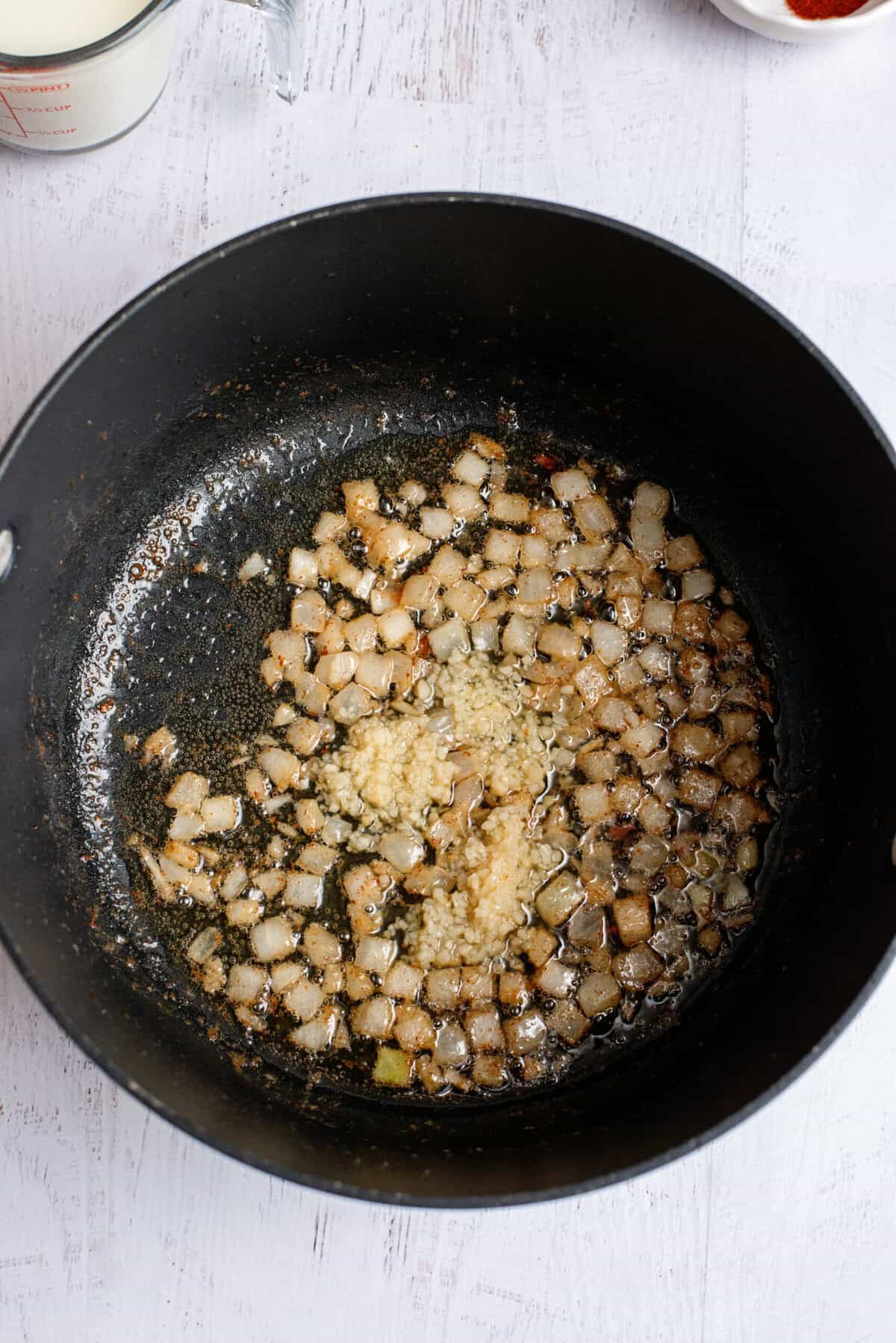 Stirring garlic with cooked, browned onions