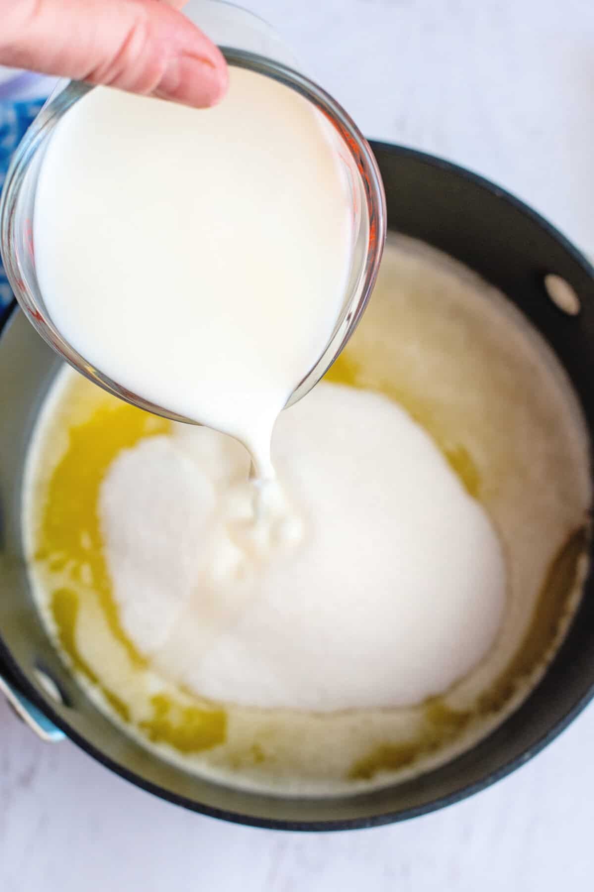 Adding buttermilk to a pot with butter and sugar