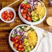 2 bowls of Cheeseburger Salad with toppings