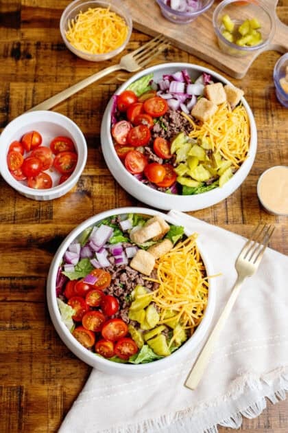 2 bowls of Cheeseburger Salad with toppings